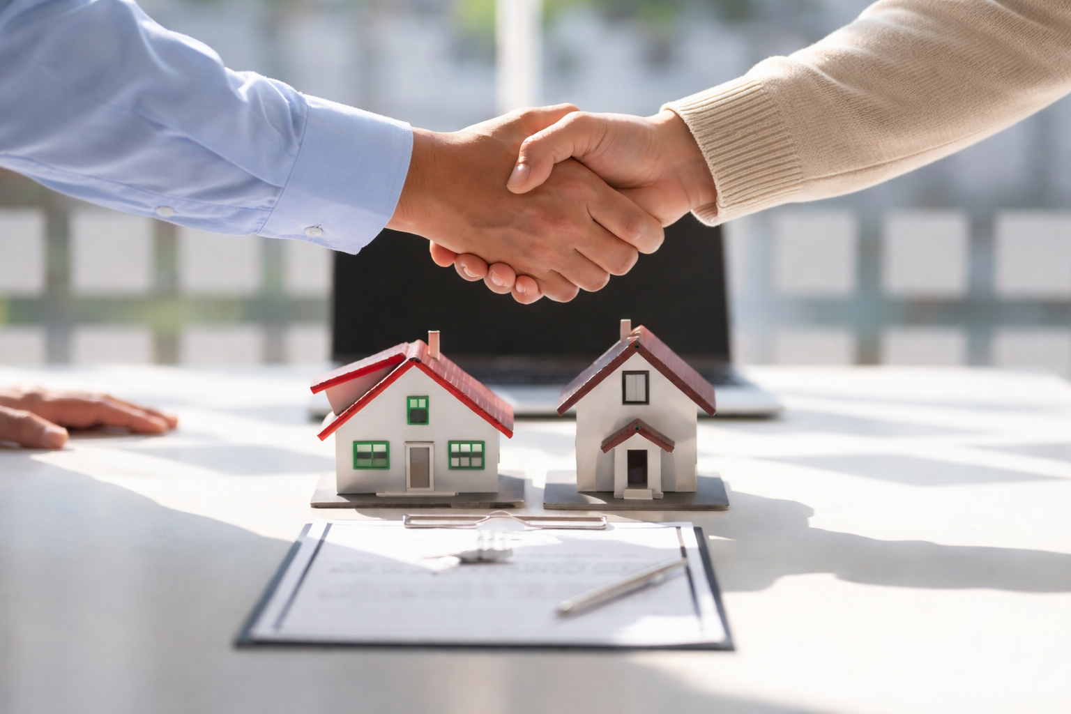 Realtor Partnership - handshake over real estate contract
